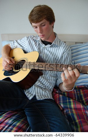 Similar – Young Boy Enjoying Music Playing Guitar Outdoors