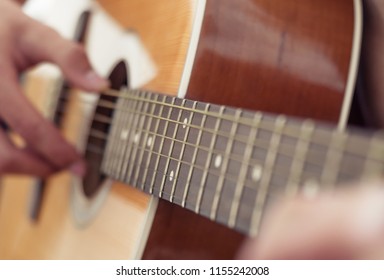 Playing guitar. Acoustic guitar in the hands of the guitarist