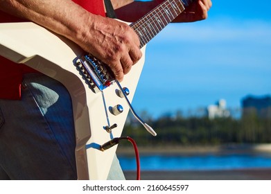 Playing Guitar On The Street. Street Guitarist. The Guitarist's Hands. Electric Guitar. Strings.