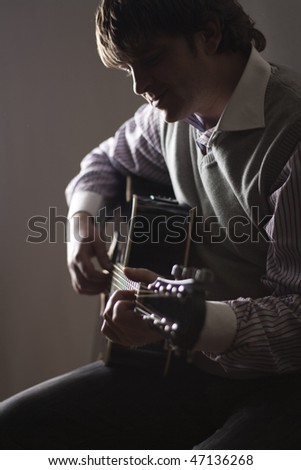Playing guitar. shot in studio