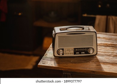 playing loud music fm channel, stylish retro radio player stands on a wooden table. stylish kitchen in the village, daylight from the window. copy space