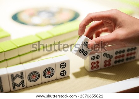 Playing Mahjong on the table