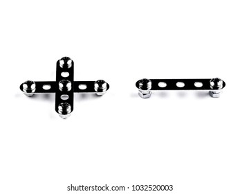 Playing math: + - built with meccano, with the effect of glossy black steel, slight slope. Isolated on white with shadows, front view