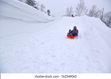 Playing On Snow Sledding With Trey  Or Snow Rafting At Winter Festival Hokkaido Japan. 
