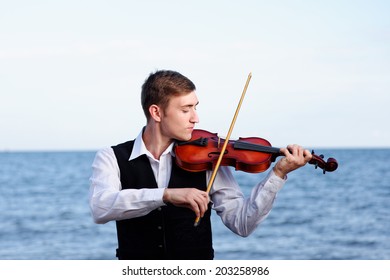 playing on violin on sea