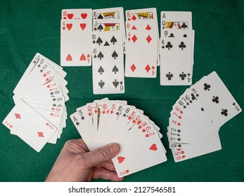 Playing Out A Hand Of Contract Bridge  On A Green Baize Card Table