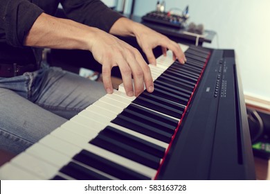 Playing the piano keyboard close up - Shutterstock ID 583163728