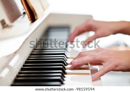 Playing Piano (shallow DOF; color toned image)