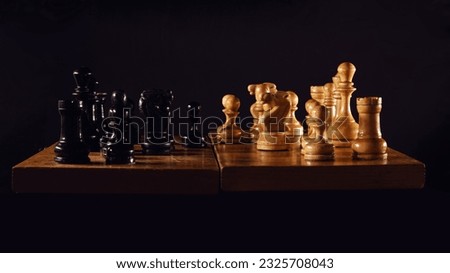 Playing with retro chess pieces in the middle game. Chess board with vintage pieces.