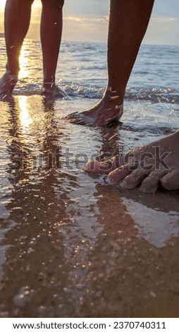 playing in the sand on the wavy beach