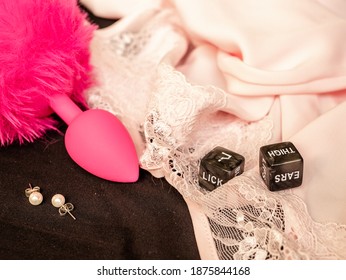 Playing sexual games with cubes. Cubes, nightgown, panties, earrings and scut on the bed. Cubes with question mark and thigh label.