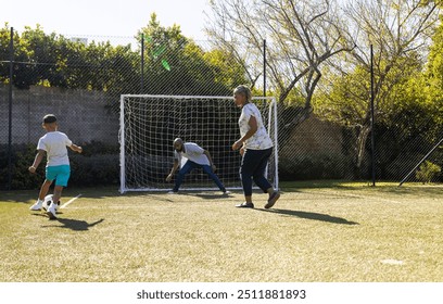 Playing soccer outdoors, grandparents and grandson enjoying time together on sunny day. bonding, recreation, teamwork, happiness, leisure - Powered by Shutterstock