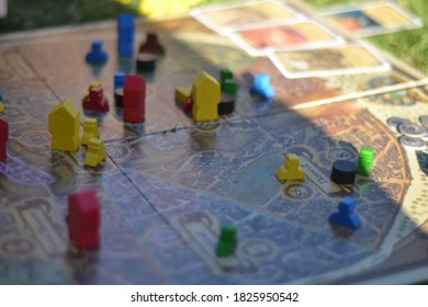 Playing The Terry Prachett Disc World Board Game During A Picnic