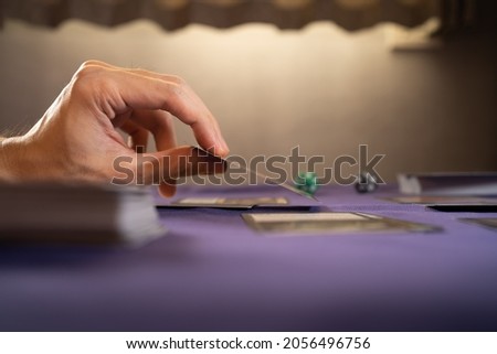 Playing trading card game on a table