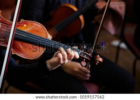 Playing the violin in orchestra 