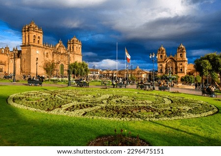 Plaza de Armas, the central square of Cusco Old town, Peru, with its famous historical landmarks the Cuzco Cathedral and the Jesuit church in dramatic sunset light