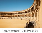 Plaza de Toros (Bullring) in Ronda, Spain. A popular and historic bullring known for its elegant neo-classical architecture featuring a double order of lowered arches.