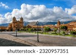 Plaza Mayor and Cusco cathedral in the Old town of Cusco city, and the Andes mountains, Peru. Plaza Mayor or Plaza de Armas is the main square of Cuzco, famous for historical colonial architecture.
