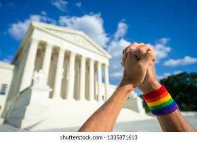 Pleading Hands Wearing Gay Pride Rainbow Flag Wristband Clasped In Prayer Outside The Supreme Court Building In Washington, DC, USA