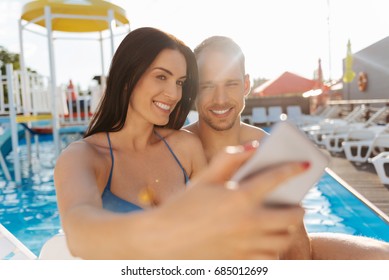 Pleasant couple taking a picture together on vacation - Powered by Shutterstock