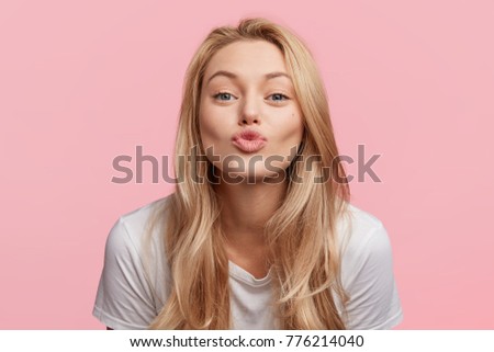 Similar – Image, Stock Photo young blonde pretty woman with orange sweater and scarf is standing at the railing outside and looks thoughtfully into the distance