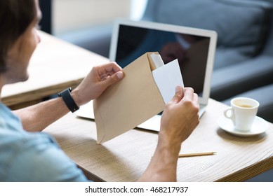 Pleasant Man Opening A Letter