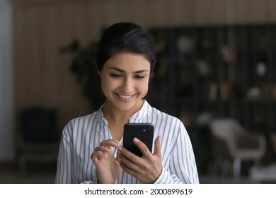 Pleasant Messaging. Happy Young Indian Woman Modern Smartphone User Chatting Texting Dating With Beloved Man Online At Social Network. Smiling Teenage Female Holding Virtual Dialogue With Good Friend