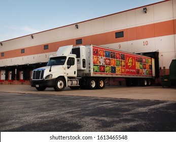 PLEASANT PRAIRIE, WISCONSIN - JULY 28, 2018: A Long Tractor Trailer Truck Decorated With Jelly Belly Logo And Colorful Jelly Bean Photos Is Pulled Into A Cargo Loading Dock At The Factory. 