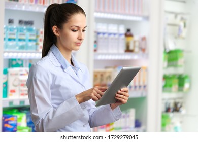 Pleasant professional young female pharmacist with a digital tablet - Powered by Shutterstock