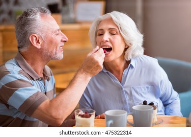 Pleasant Senior Couple Sitting At The Table