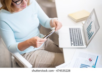 Pleasant Senior Woman Opening A Letter