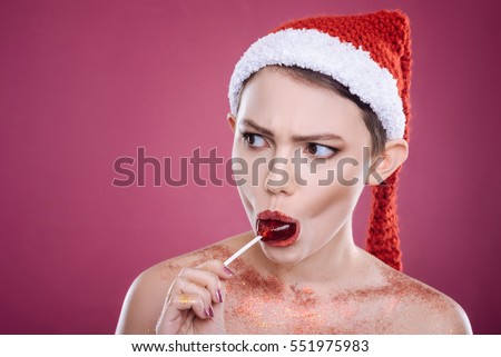 Pleasant woman eating lollipop
