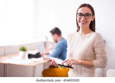 Pleasant Woman Holding Tablet