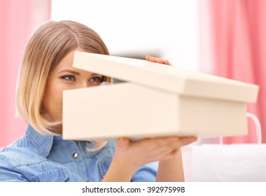 Pleasant Woman Opening Box With Shoes