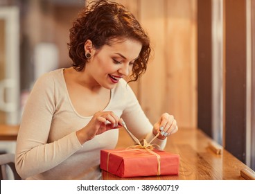 Pleasant Woman Opening Present