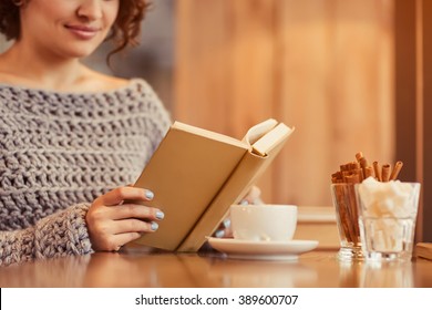 Pleasant Woman Reading Book In The Cafe