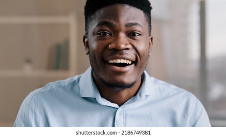 Pleasantly Surprised African American Man Wears Blue Shirt Makes Big Eyes Feels Shock Open Mouth In Astonishment Wow Reaction Joyful Happy Amazed Male Face Expression Looks At Camera Hears Good News