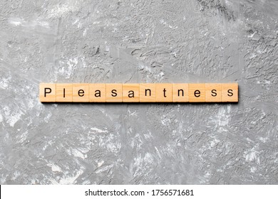 pleasantness word written on wood block. pleasantness text on cement table for your desing, concept. - Shutterstock ID 1756571681