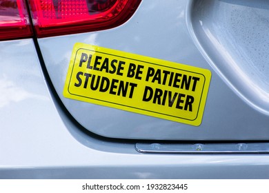 Please Be Patient Student Driver - yellow bumper sticker on the car rear door