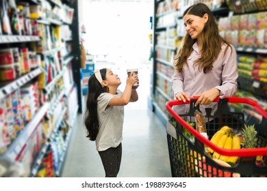 Please, Buy Me Chocolate. Adorable Little Girl Asking Her Pretty Mom To Buy Her Hazelnut Cream For Breakfast At The Supermarket 