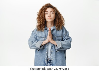 Please. Cute Curly Girl Asking, Begging For Smth, Looking Needy And Silly, Holding Hands In Praying Gesture, Standing Over White Background.