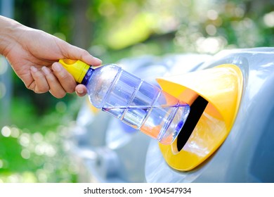 Please Dispose Of Plastic Bottle Into The Tank. A Man Throw Rubbish In The Trash Can By Separate Garbage To Dispose Like Hazardous Waste ,