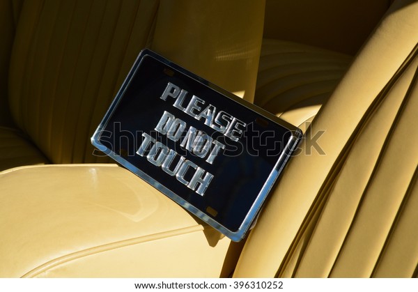 Please do not touch metal sign in the interior\
of a new vehicle.