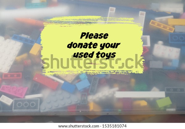 Please donate your\
used toys in black text on a box of colorful novelty items and\
knickknacks for children.\
