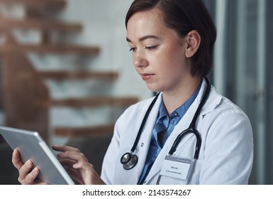 Please Email Me When You Get The Chance. Shot Of A Young Female Doctor Taking A Break To Use Her Digital Tablet.