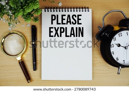 Please Explain text written on notepad with alarm clock and magnifying glass flat lay on wooden background
