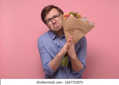 Please forgive me for cheating. Funny man need a help or forgiveness from his girlfriend. Isolated on pink background, studio shot - Shutterstock ID 1667721871