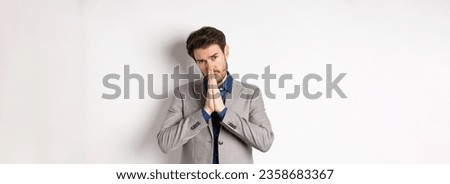 Please help. Pleading man in suit asking for favour, begging you, standing on white background.