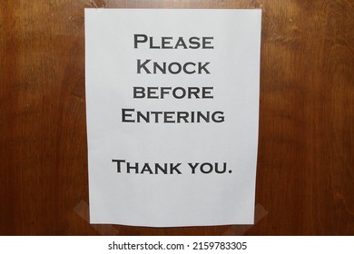 Please Knock Sign On A Wooden Door