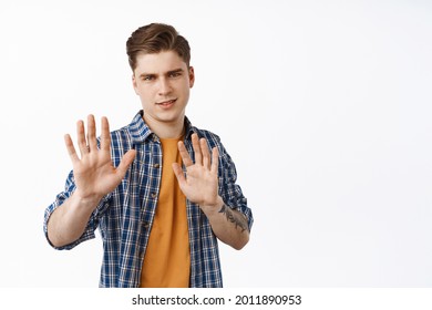 Please Stop. Annoyed And Reluctant Man Showing Stay Back, Dont Come Closer Gesture, Refusing And Saying No, Rejecting Offer, Standing Over White Background